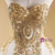 Close up of intricate gold floral appliqués on wedding dress bodice