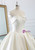Close-up of the strapless sweetheart bodice and structured satin fabric on a ball gown wedding dress