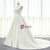 Side view of an ivory satin wedding dress, showing the subtle trumpet silhouette and the elegant flow of the train