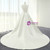 Dramatic backless design on an ivory satin wedding dress, featuring V-neck back with ribbon crisscross lacing and a train