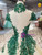 	Dramatic backless design on a high neck champagne wedding gown with lace up back