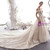Floor-length champagne wedding gown with sweeping train and floral lace appliques
