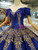 Close-up of gold sequin and floral bead details on a royal blue tulle wedding dress