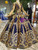 Close up of royal blue sequined wedding dress with intricate gold sequin appliques