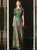 Close-up of intricate green sequin appliqués layered over soft champagne tulle on a formal mother of the bride dress.