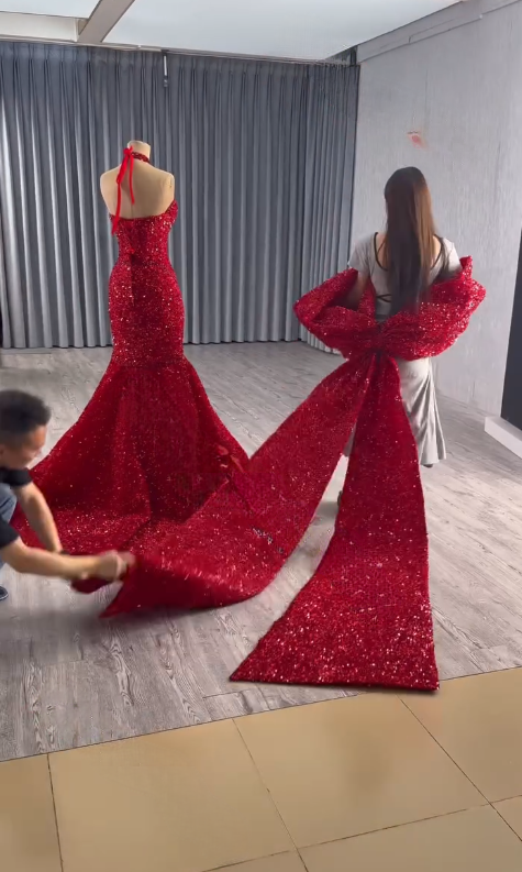 Detachable Butterfly Train Construction Artisans arranging detachable butterfly shaped train on red wedding gown