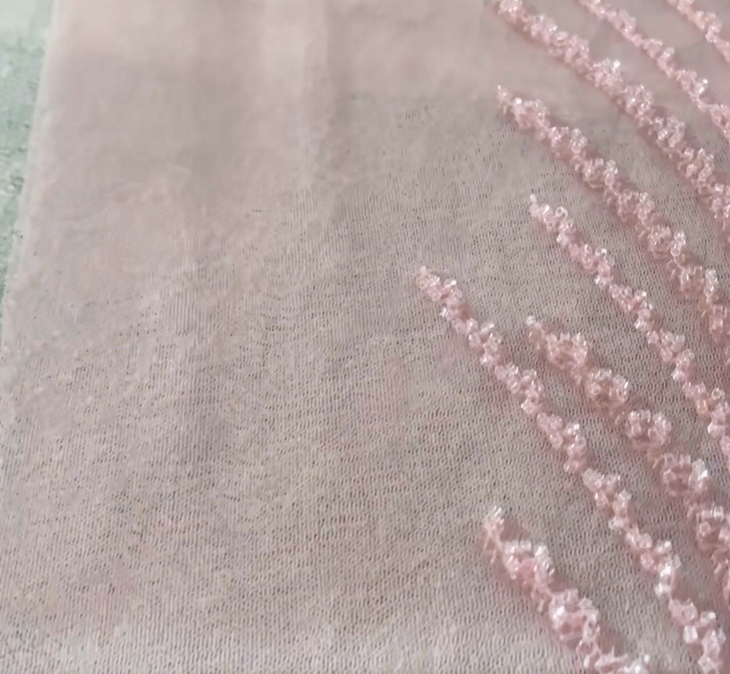 Willow Inspired Beaded Lines on Pink Ball Gown Skirt Willow branch inspired beaded lines spreading across a pink ball gown skirt