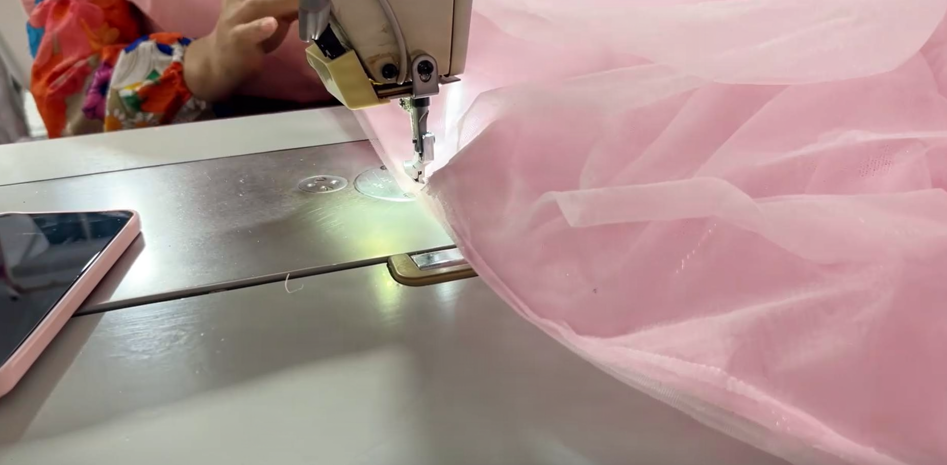 Hand Stitching Sequin Details on Pink Ball Gown Close up of hand stitching sequin details on pink ball gown