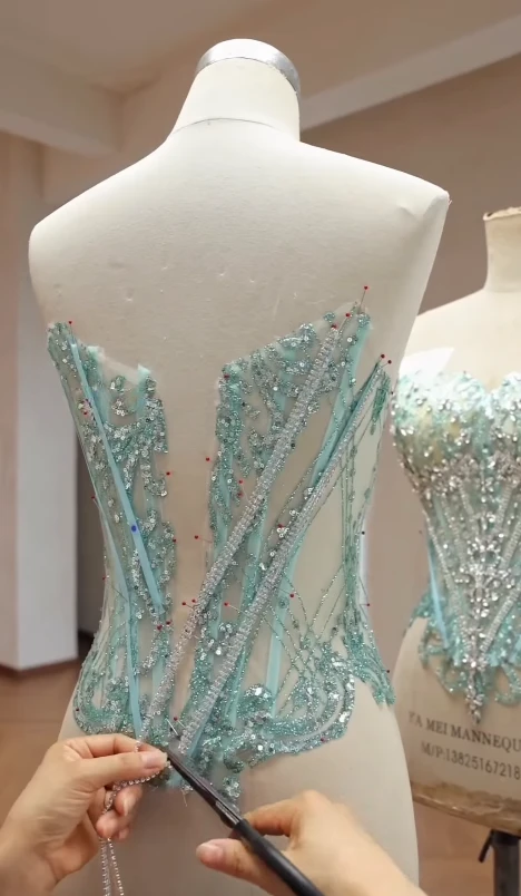 Cutting rhinestone crystal chain to length for the green ball gown bodice