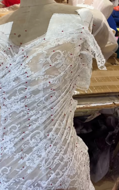 Eyelash lace pleats being shaped on a fitted mermaid wedding dress