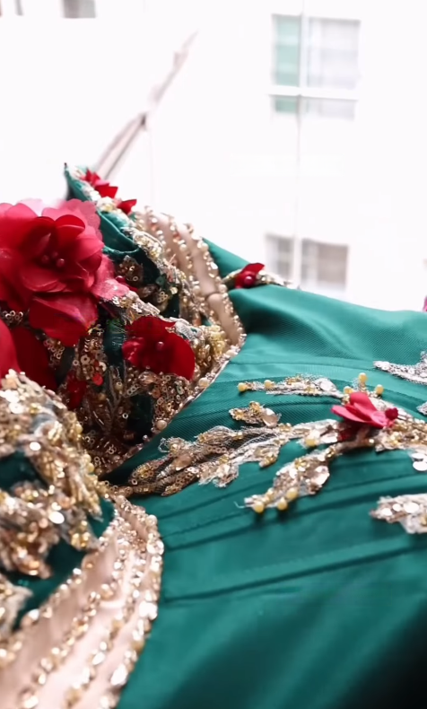 Finished green gown bodice with red floral detail
