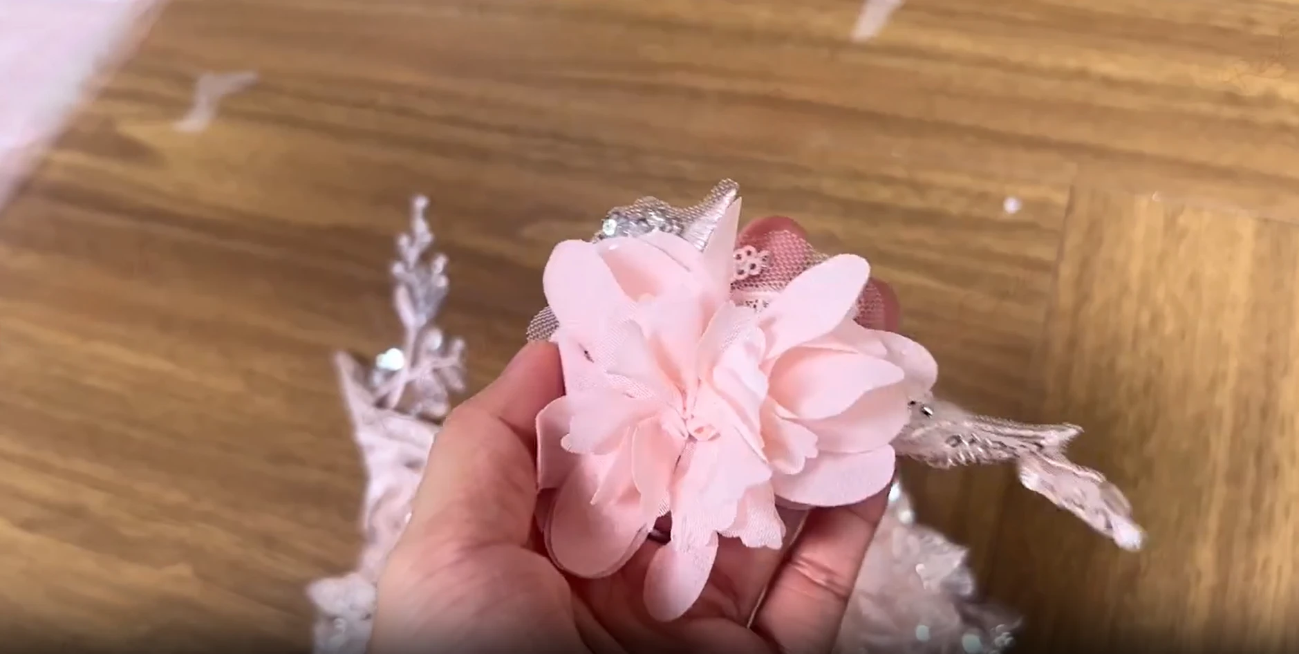 Handmade three dimensional pink fabric flower ornament for a couture ball gown