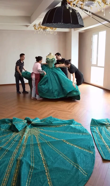 Dressmakers arranging the voluminous gown train