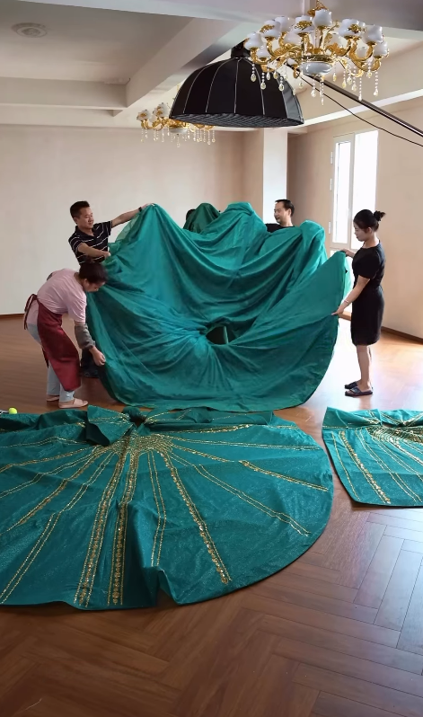 Workshop team assembling oversized ball gown skirt