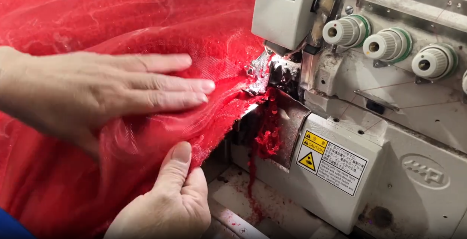 Finishing raw edges of red sequin wedding dress fabric
