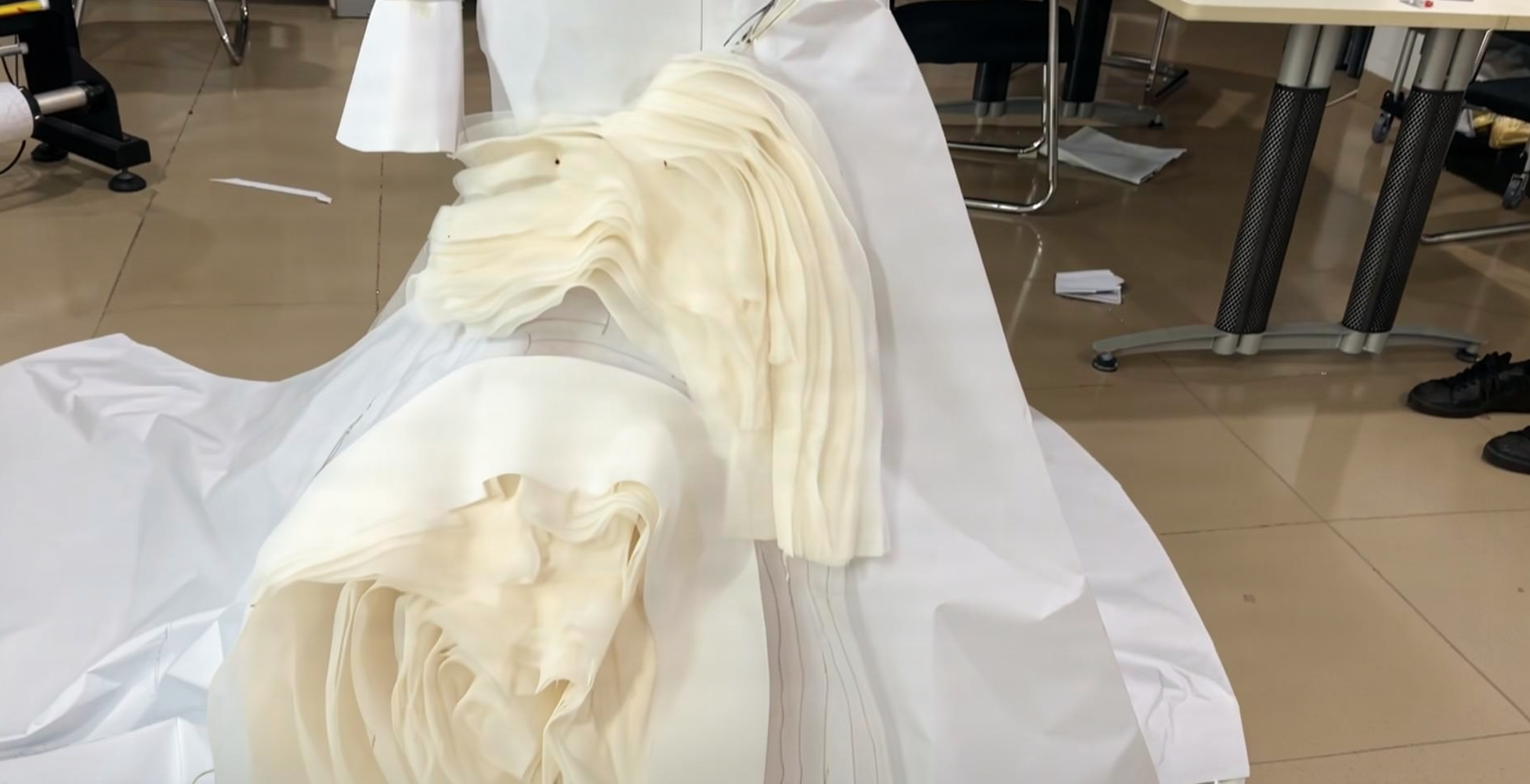 Paper toile pattern beside the finished lace mermaid wedding dress