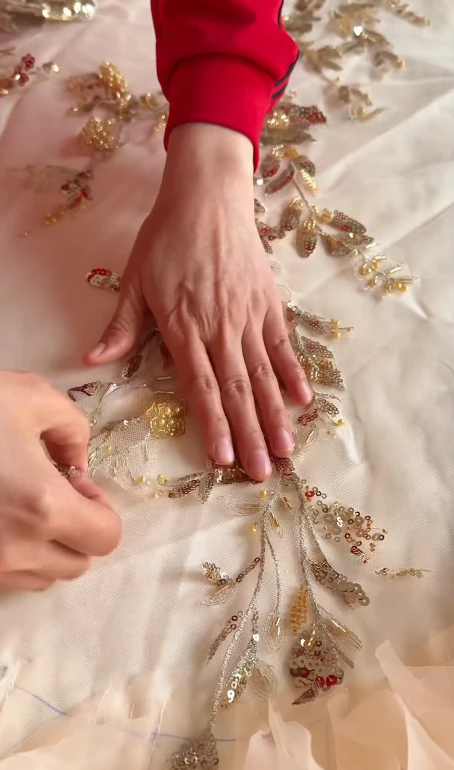 Floral appliqué pinned in position before hand beading Floral appliqué pinned in position before hand beading