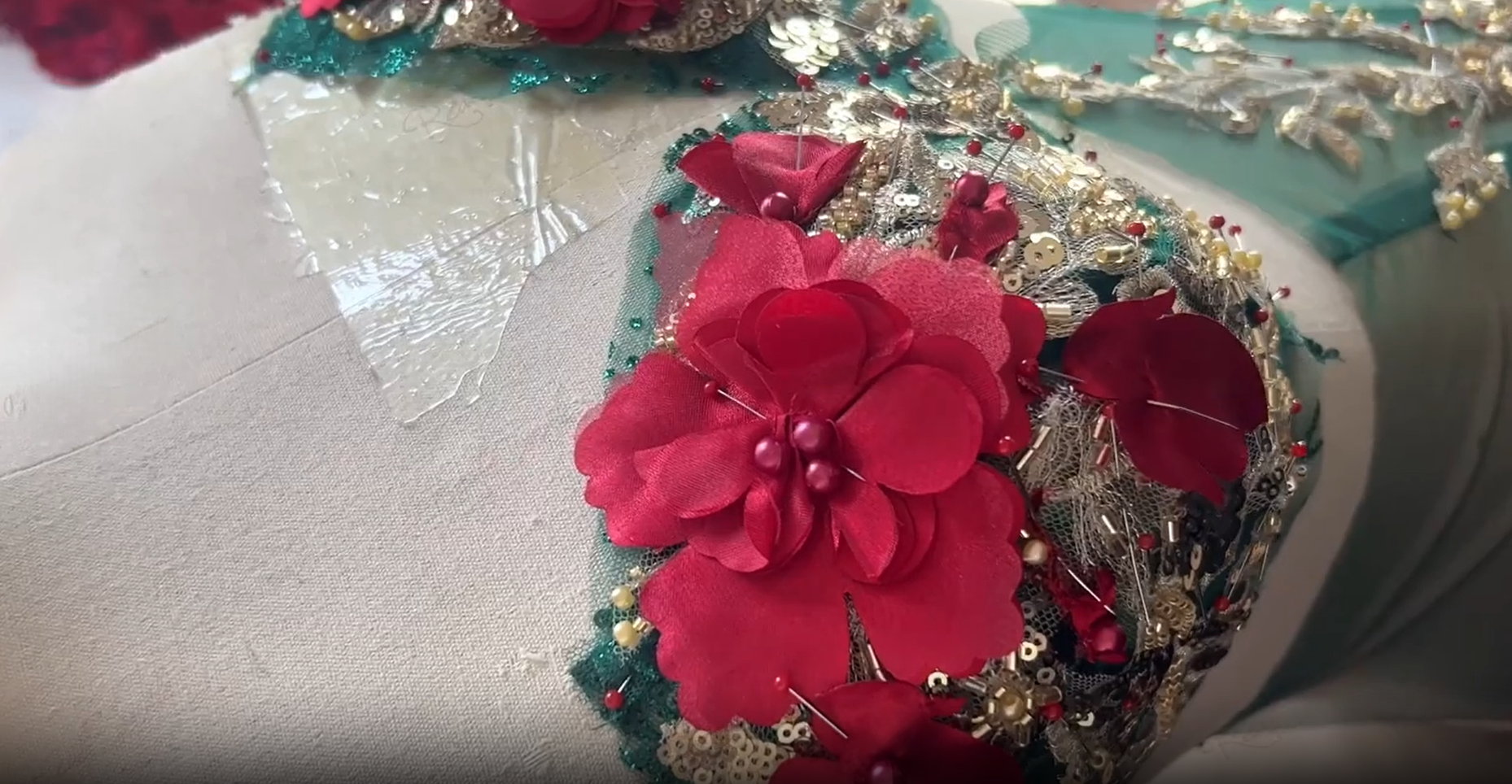 Red flower and gold sequin bodice detail