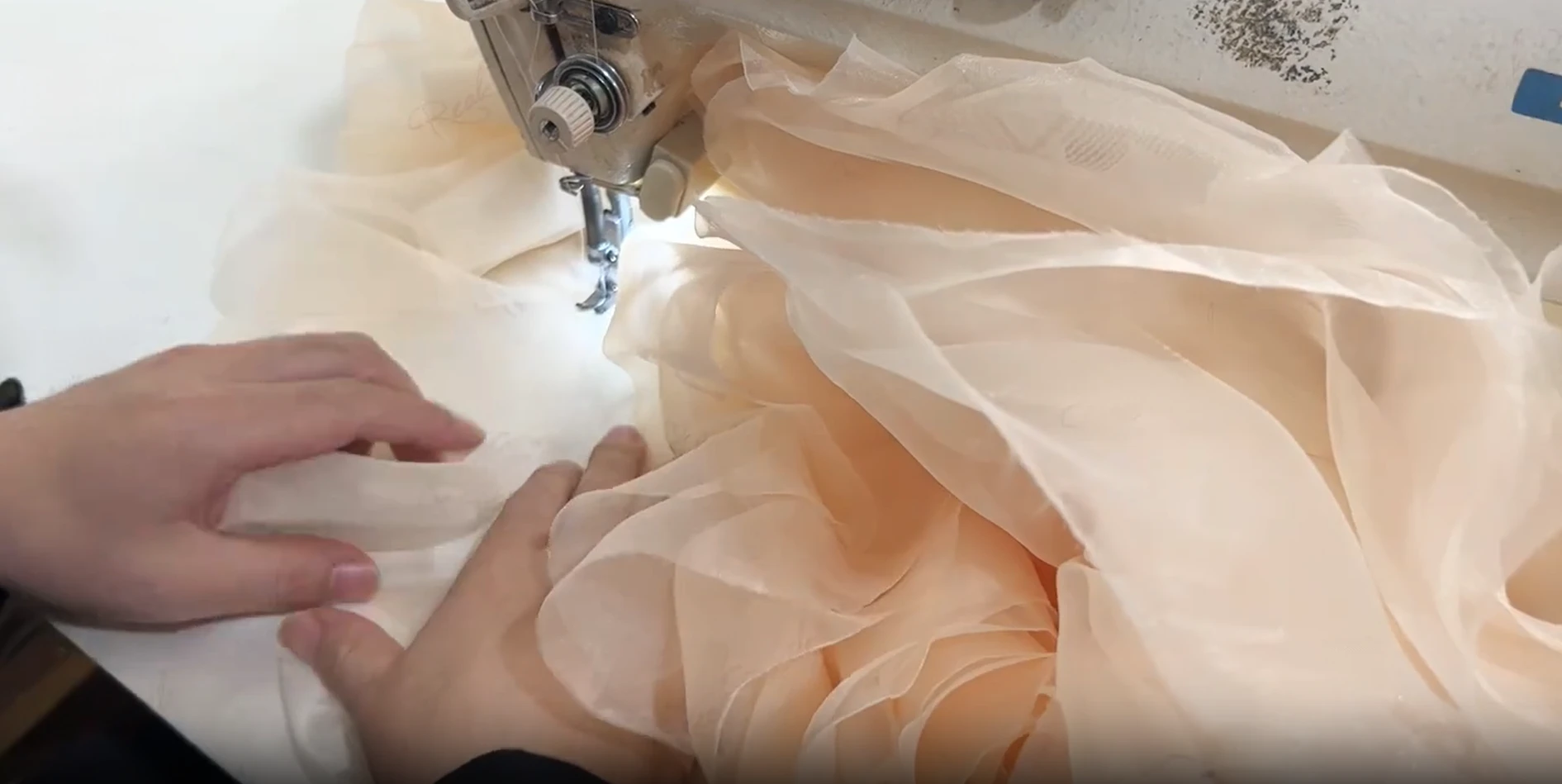 Champagne tulle layers being sewn for the gown skirt Champagne tulle layers being sewn for the gown skirt