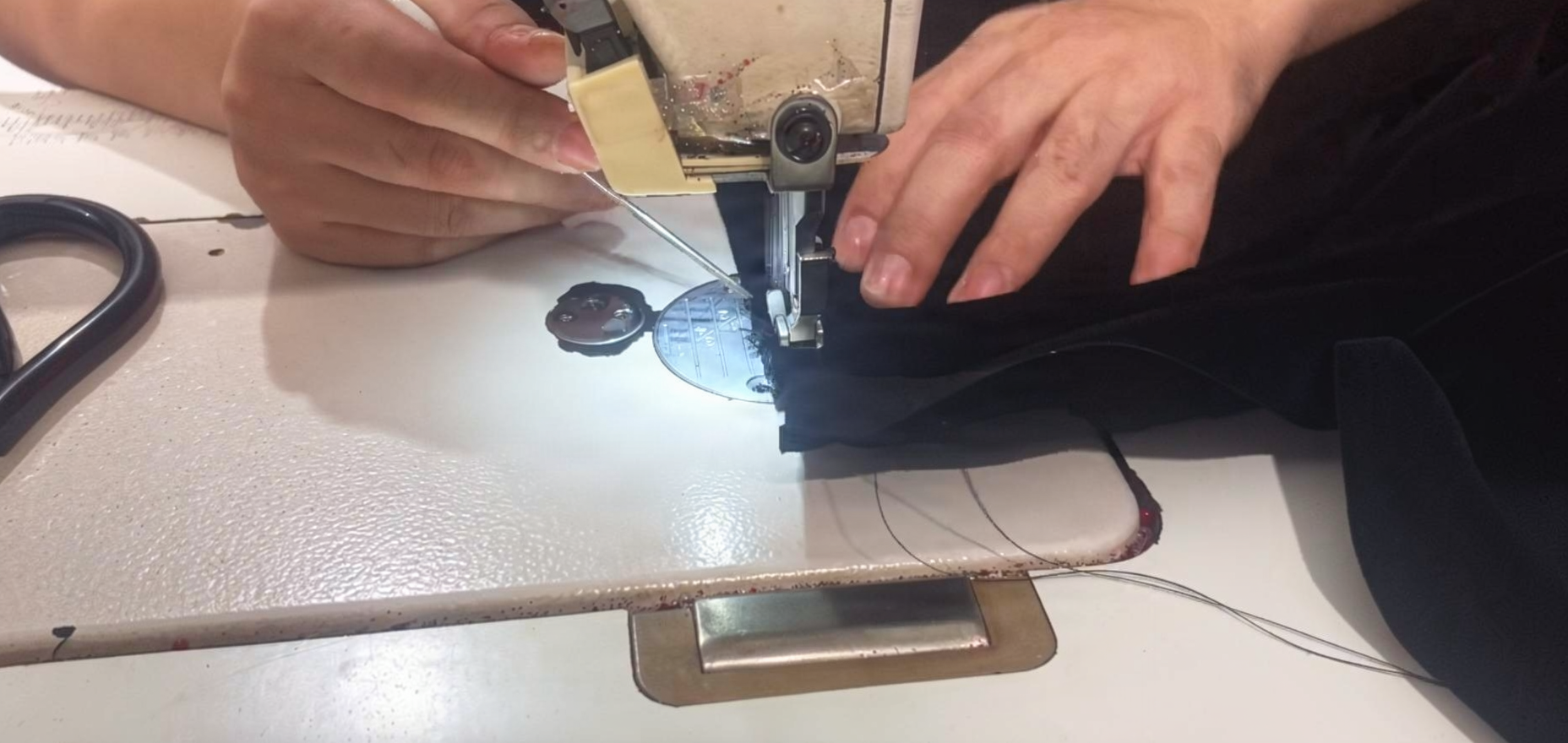 Sewing machine stitching black velvet wedding gown bodice panel