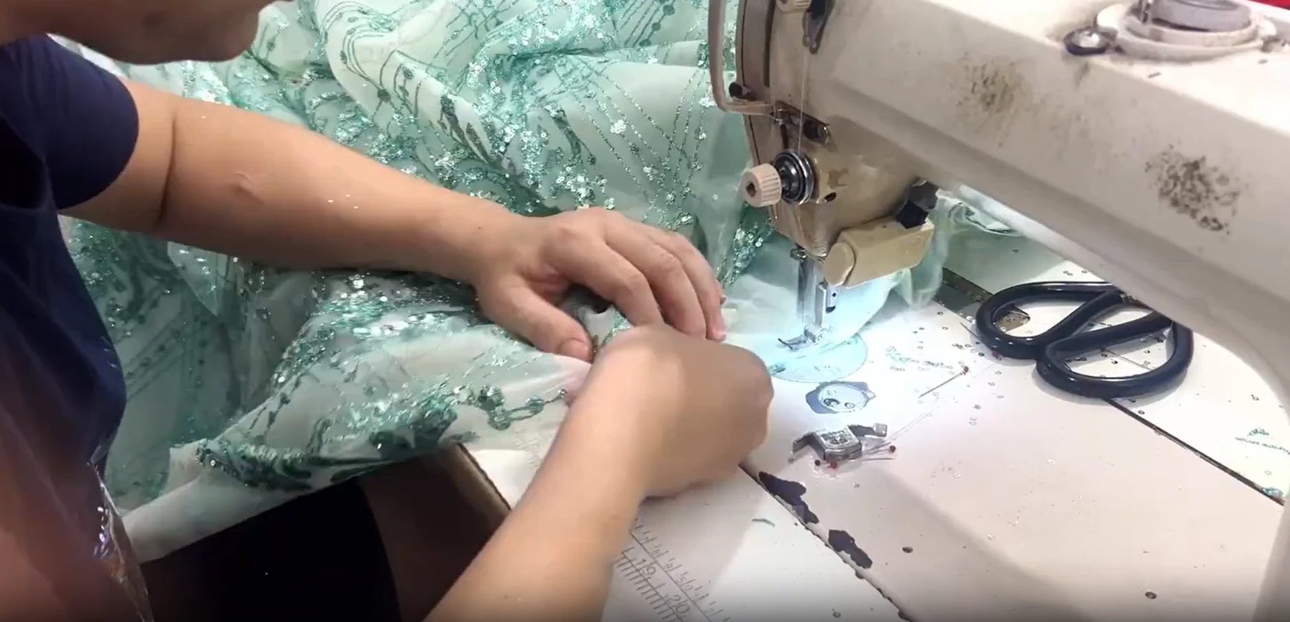 Sewing sequined tulle panels for the mint green ball gown