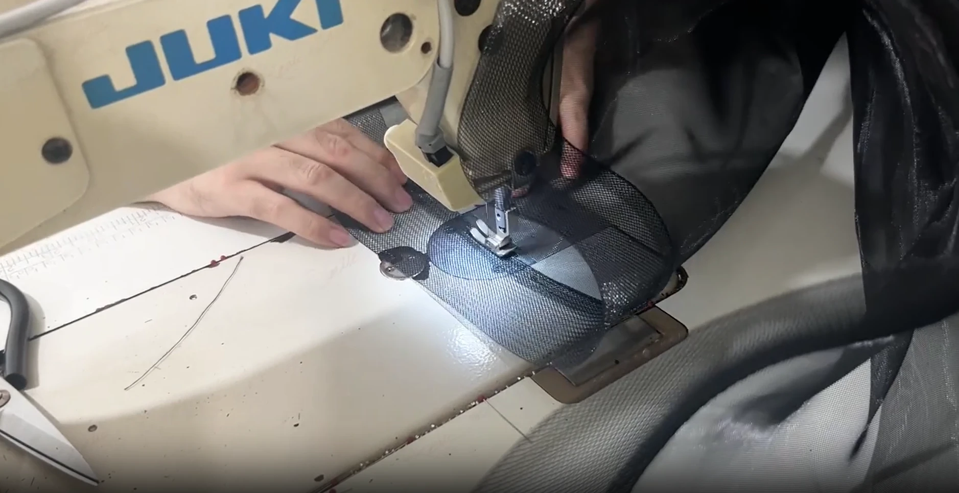 Stitching dark fabric during black gown construction