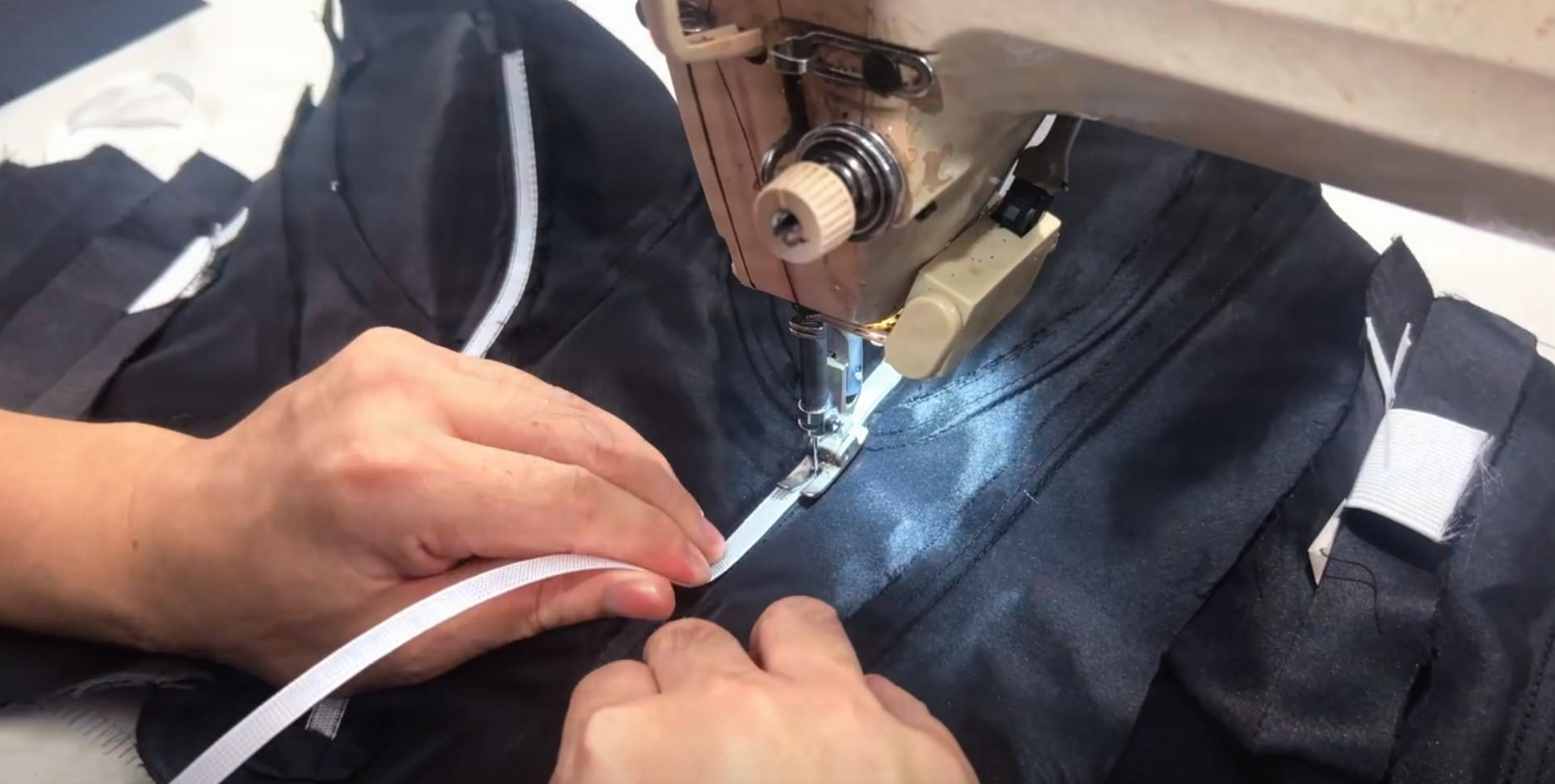 Straight stitching Rigilene woven polyester boning into custom black wedding dress