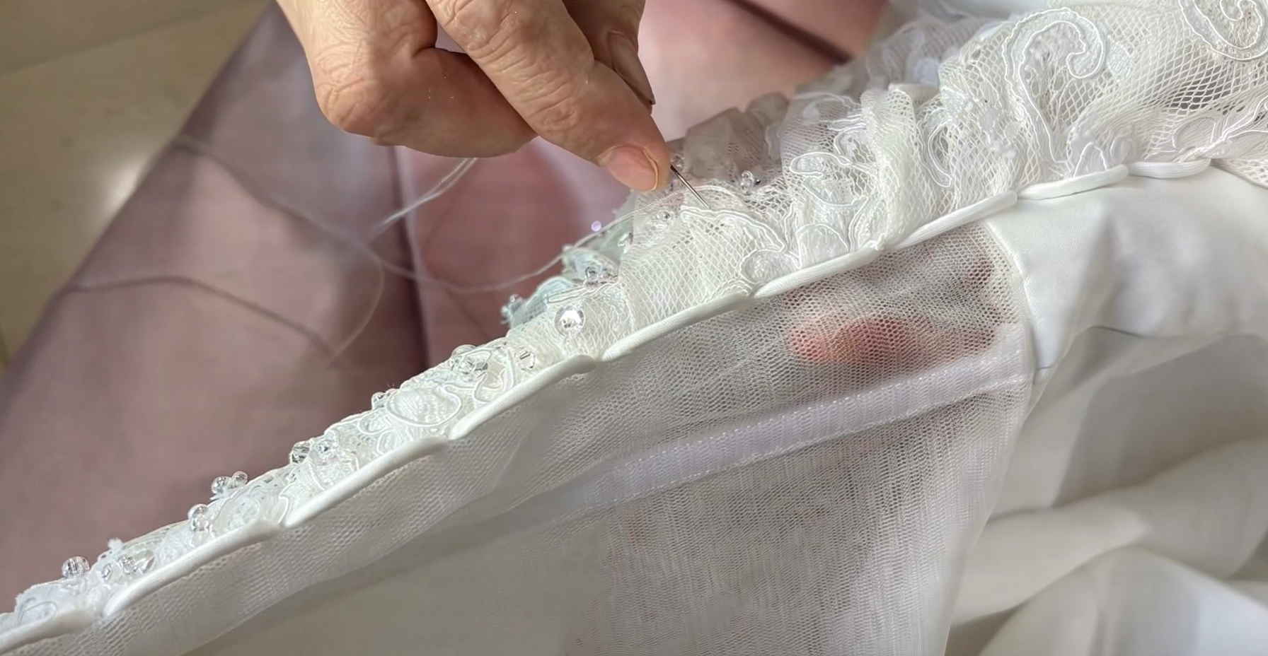 Tiny beads hand sewn into delicate wedding dress lace fabric