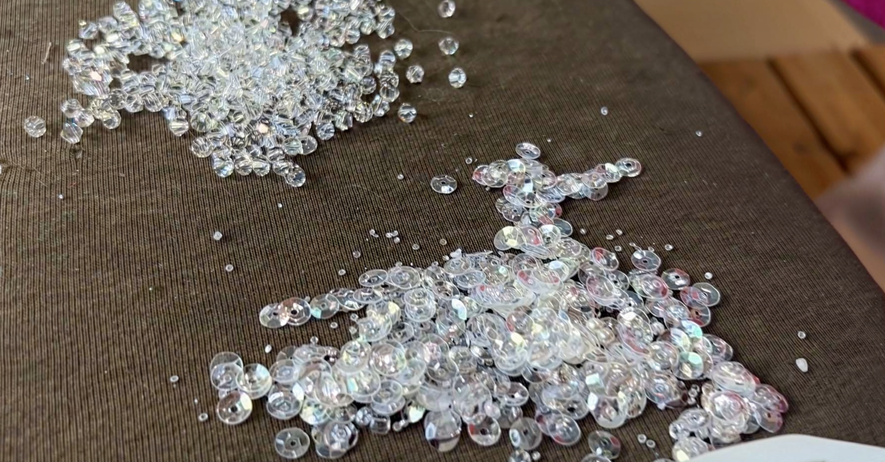 Tiny iridescent beads and sequins prepared for embellishing wedding dress lace