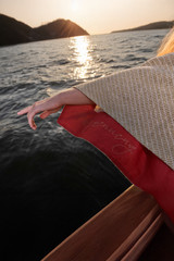 Kashesh Falak Coat in ivory and gold: A women's mid-length handwoven jacket made from recycled fabrics, featuring dramatic wide sleeves and a peek of bright red silk lining