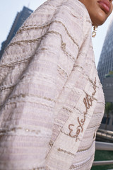 Kashesh Haadiya Coat in Ivory: Women's handwoven long jacket made from recycled fabrics, featuring 'Excellence' sequin trim and a red silk lining