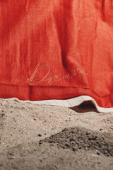 Kashesh Ruhee Coat: A cream and gold handwoven mid-length trench coat featuring a statement lapel, luxurious red silk lining, and a belt with 'Dream' sequined detailing