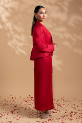 Kashesh Global Pataka Ensemble: A striking scarlet red overlap dress in a linen-satin blend, worn with a structured puff-sleeve statement jacket featuring genuine rose quartz hand-embroidery