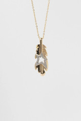 18k gold-plated feather pendant necklace with crystal star detail, isolated on a white background.