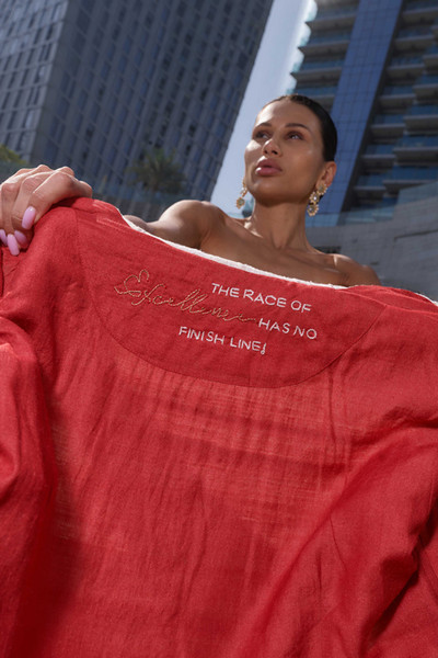 Kashesh Haadiya Coat in Ivory: Women's handwoven long jacket made from recycled fabrics, featuring 'Excellence' sequin trim and a red silk lining