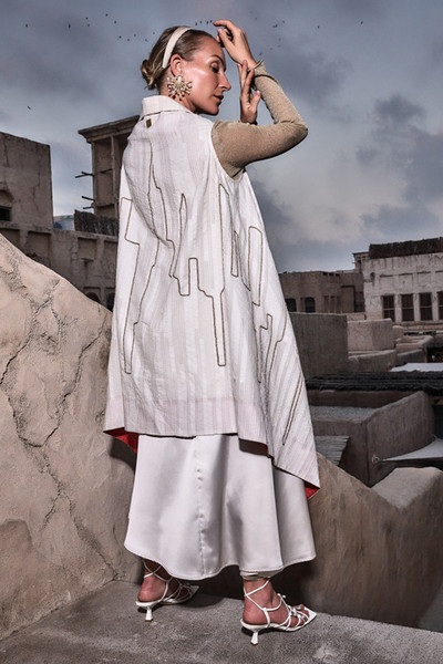 Kashesh Mahira Coat Ivory - Cream handwoven women's vest jacket featuring a glittering sequin Dubai skyline design and recycled fabric texture