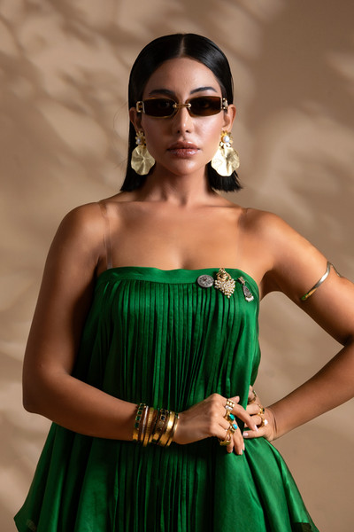 Kashesh 'Fuljadi' emerald green strapless ensemble featuring a flowing 50/50 linen-satin top with delicate tassel accents and a detachable brooch, paired with slim tailored pants