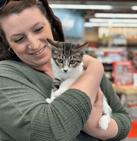 Lady holding cat in Pet Food Express store