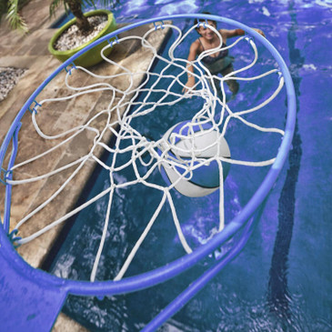 Blue and white basketball going through pool hoop net with swimmer watching from water
