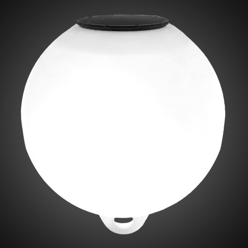 Glowing white solar-powered buoy illuminated at night with internal LED light engine Glowing white solar-powered buoy illuminated at night with internal LED light engine