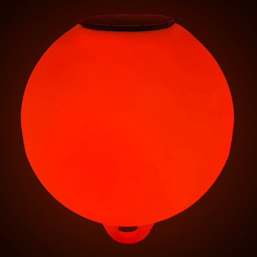 Glowing red solar-powered buoy illuminated at night with internal LED light engine Glowing red solar-powered buoy illuminated at night with internal LED light engine