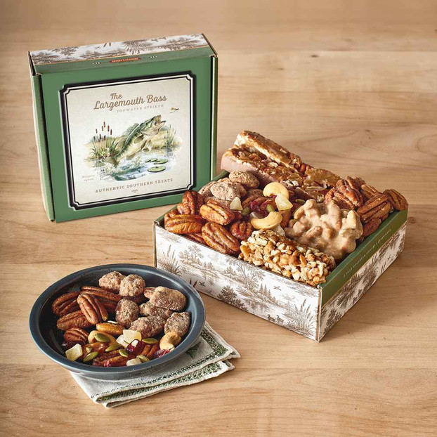 Priester’s Largemouth Bass Gift Box with an illustrated bass lid, assorted pecan treats, and a bowl of nuts.