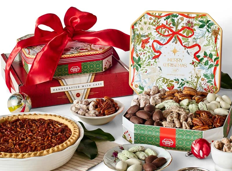 Priester's Fans Favorites Tower holiday gift set with chocolate and praline pecans, a pecan pie, and festive tins tied with a red bow