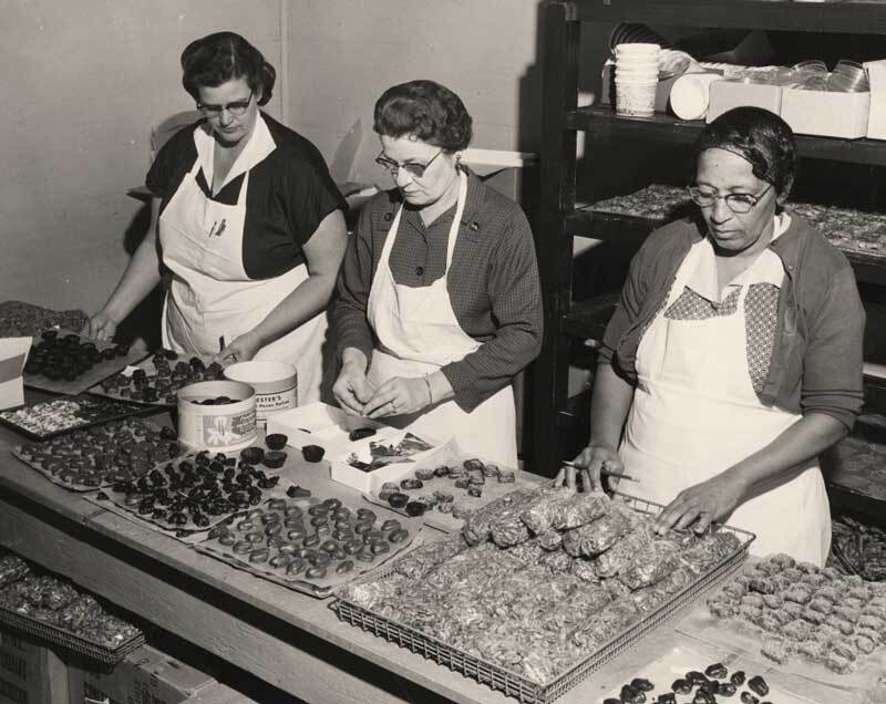 Archival photo of Priester's Pecans employees hand-preparing pecan candies in the company's Fort Deposit, Alabama kitchen