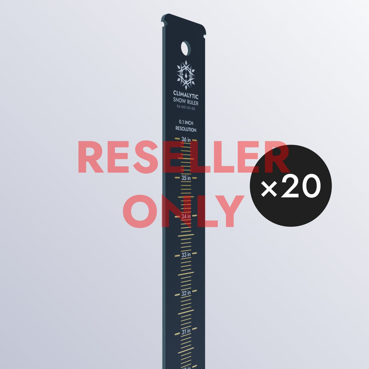 A black snow ruler with white text and gold graduations. Text indicating that 20 rulers come in this case.