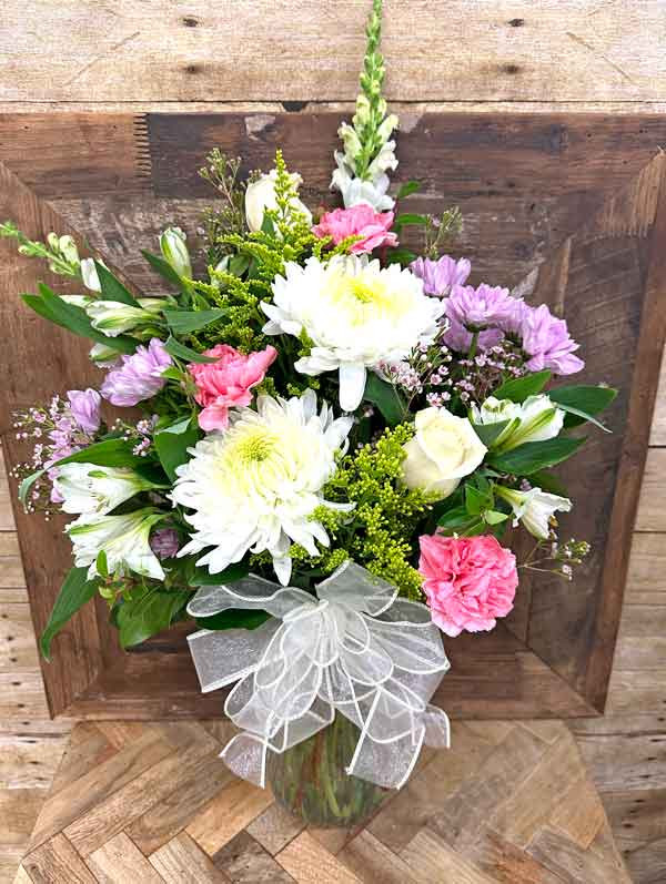 Soft pastel flower arrangement with white chrysanthemums and pink flowers in a glass vase – Gilbertsville PA florist