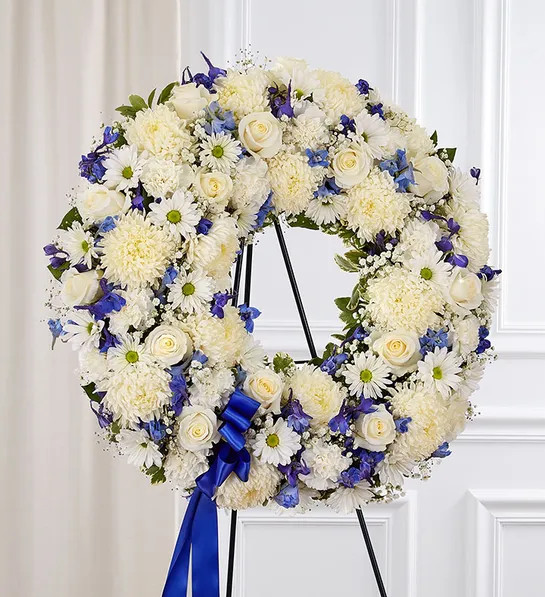 Traditional standing funeral wreath with red and white flowers available for local delivery in Gilbertsville, PA