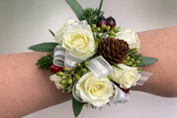White rose wrist corsage with ribbon for wedding or formal event