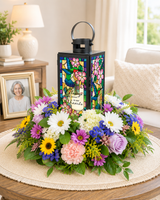 Decorative sympathy lantern arranged with fresh flowers for a celebration of life tribute