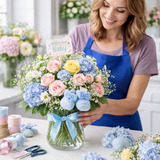 florist designing new baby flower arrangement in vase with pastel flowers gilbertsville florist